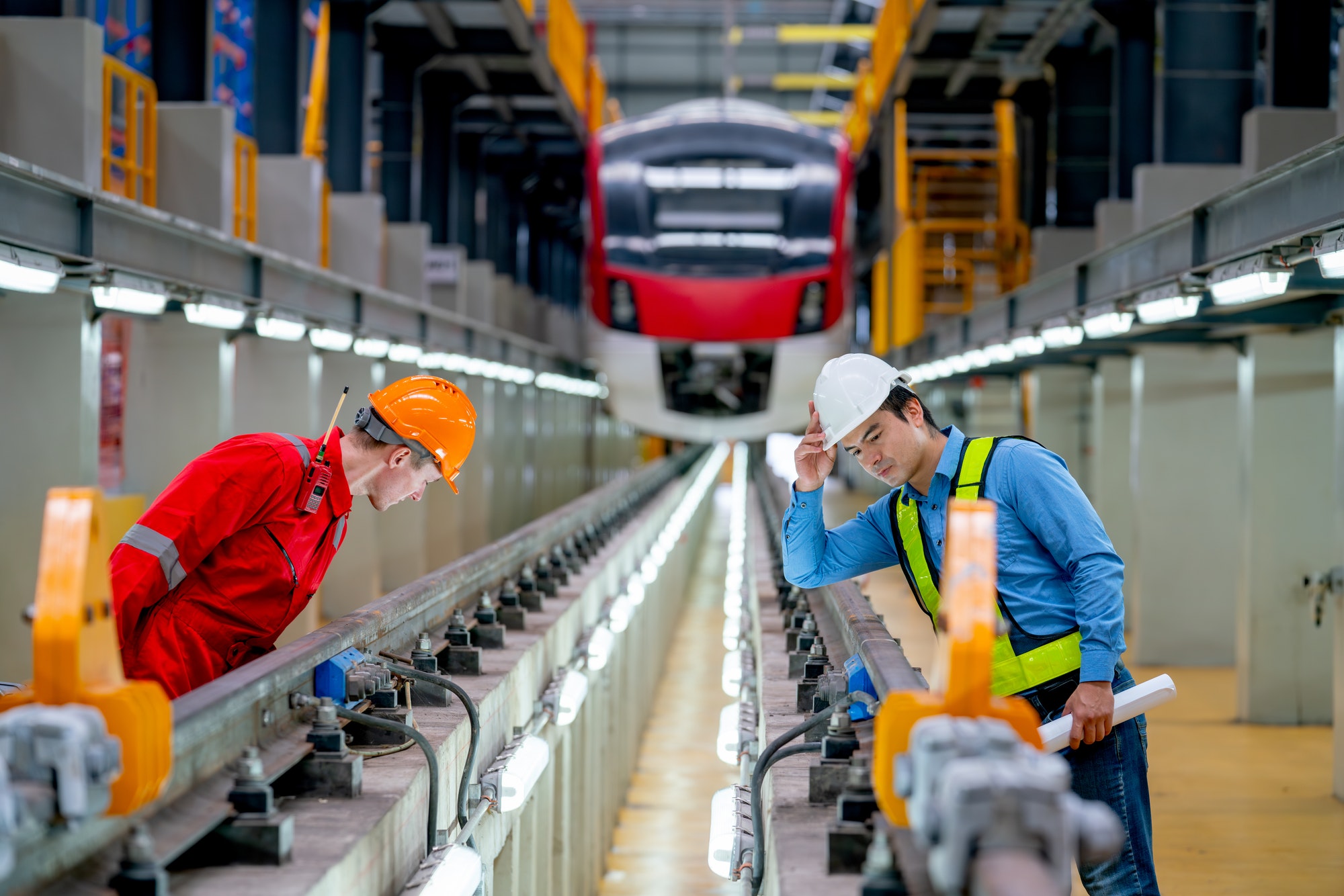 Professional engineer and technician worker look and check function of railroad tracks of train