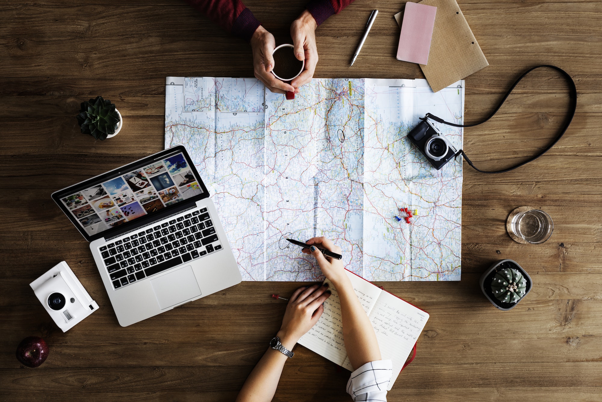 Travellers planning a trip on a map